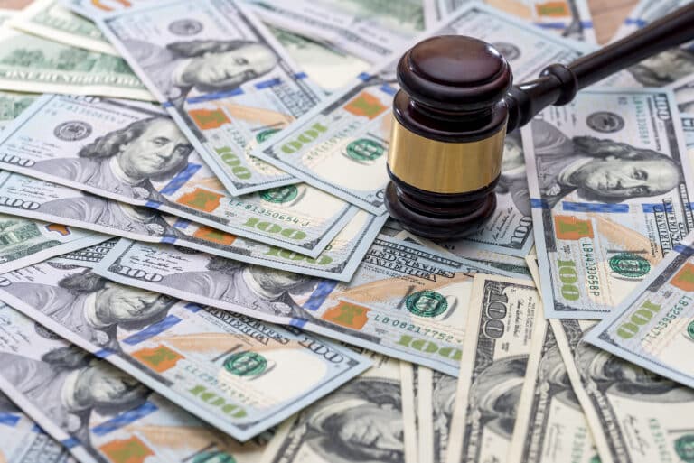 wooden gavel with usa dollar on desk. close up.