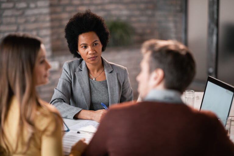 Financial advisor having a business meeting with her clients in the office.